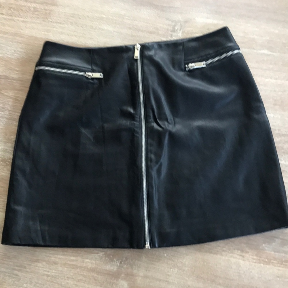 Black leather-like, zip fro t skirt.